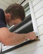 Finished replacement window installation with trim and exterior caulk applied